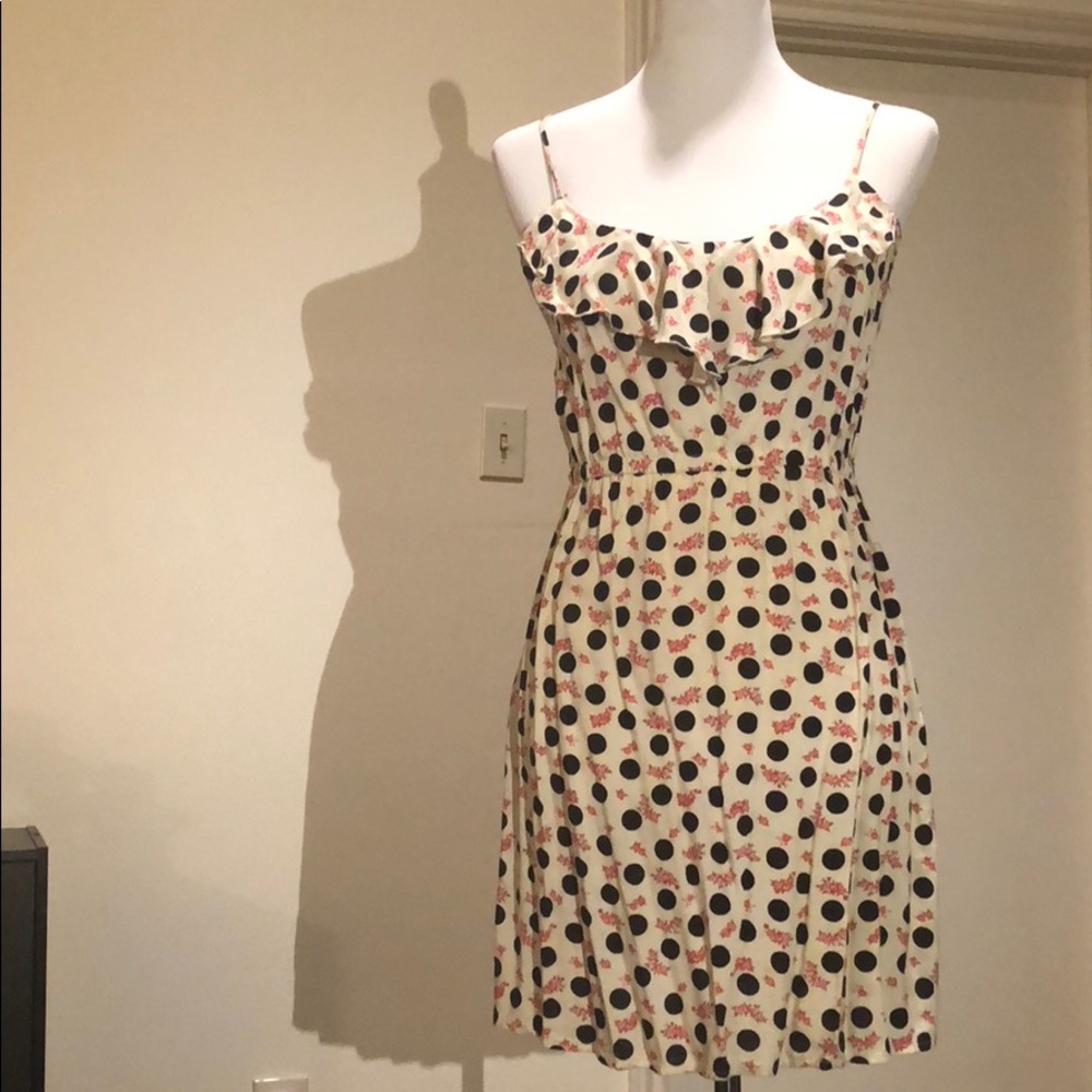 White polka dot dress with pink flowers.